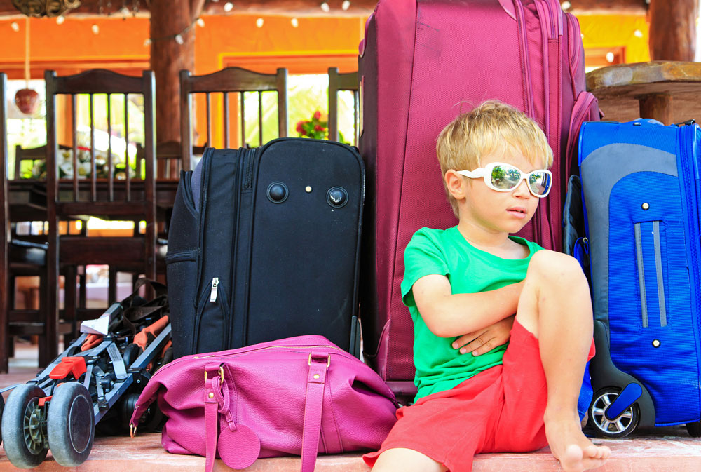 bigstock-little-boy-sitting-on-suitcase-82514993-web
